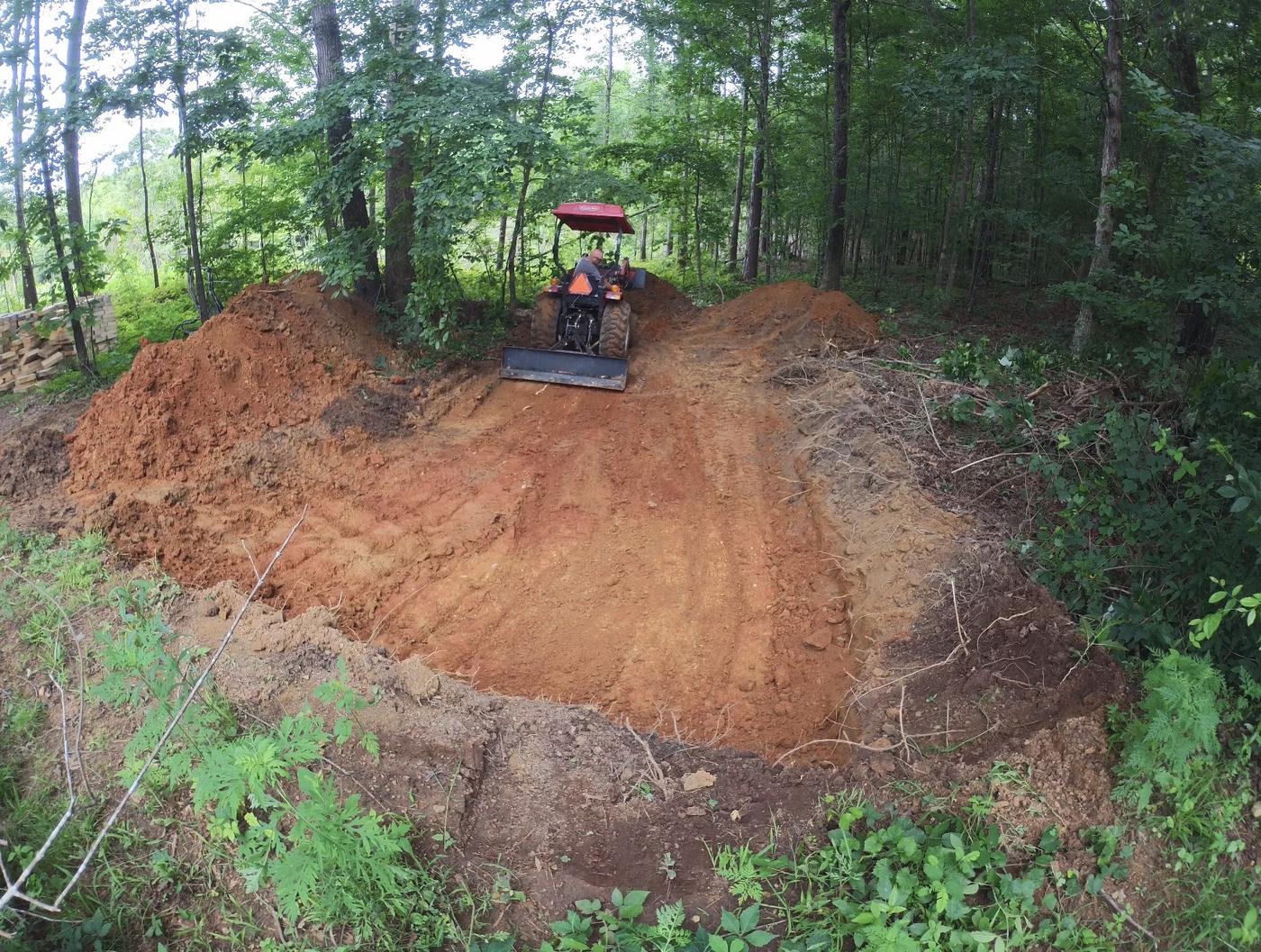 The big dig for the root cellar, tractor clearing the site